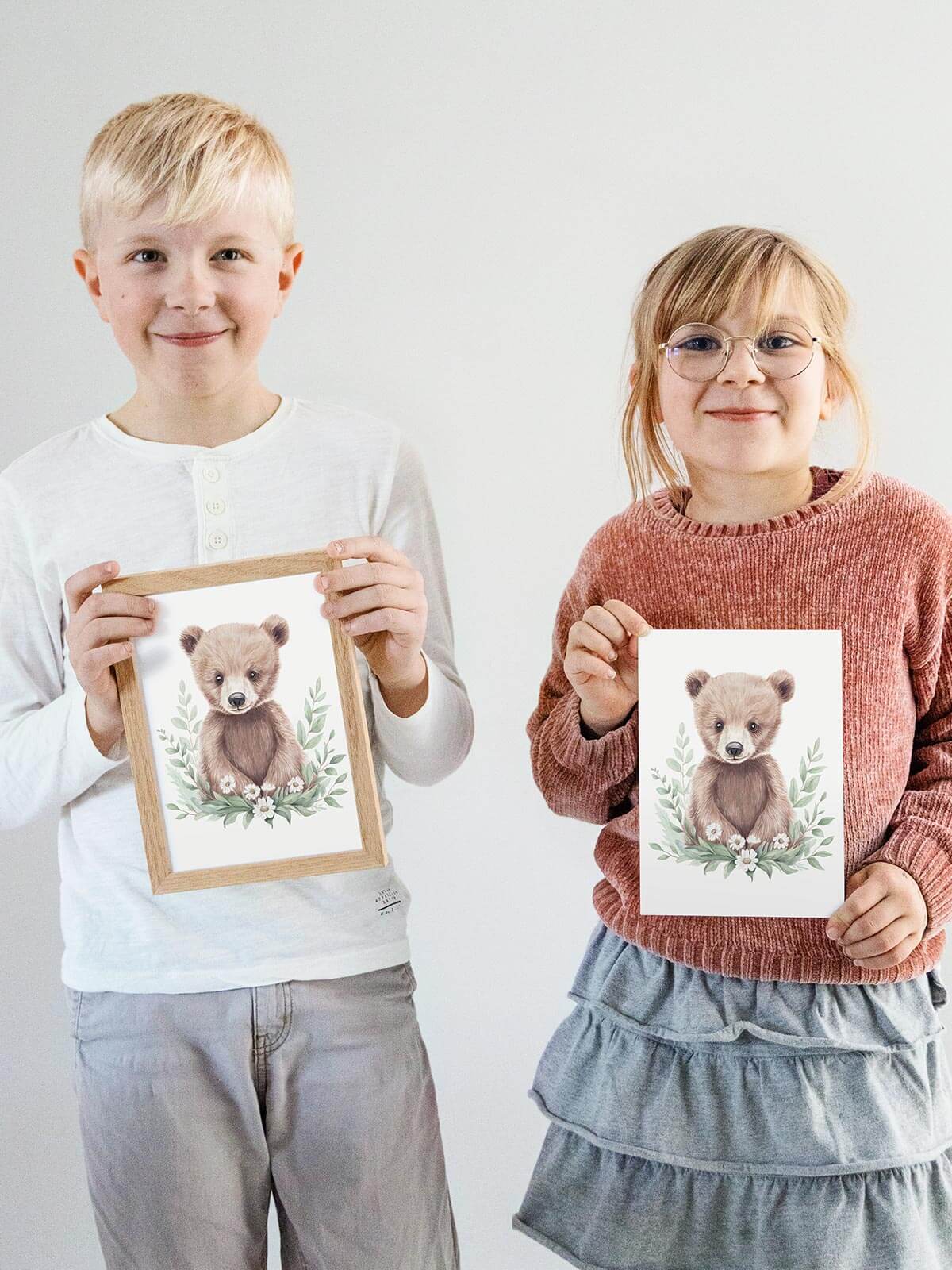 Barn håller handmålat A5-kort med björnen Benji i ekram
